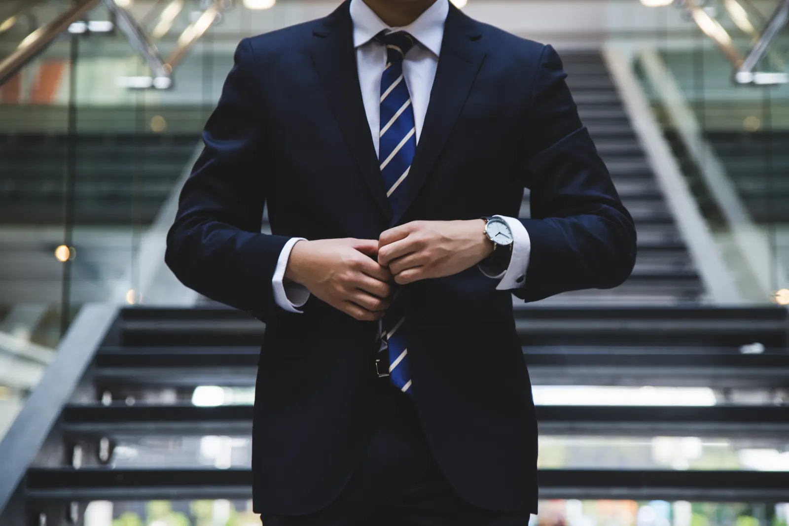 A figure in a suit on an escalator